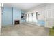 This bright living room showcases a fireplace, built-in shelving, and natural light from a large window at 305 N Ellis Ave, Dunn, NC 28334