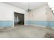 Spacious living room with blue trim, chandelier, and view into another room, ready for renovation at 305 N Ellis Ave, Dunn, NC 28334