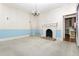 Spacious living room featuring a decorative fireplace, classic chandelier, and bright natural light at 305 N Ellis Ave, Dunn, NC 28334