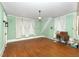 Open room with hardwood flooring and mint colored walls at 305 N Ellis Ave, Dunn, NC 28334