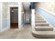 Traditional carpeted stairway with blue and floral wallpaper, leading to the upper level of the home at 305 N Ellis Ave, Dunn, NC 28334
