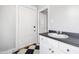 Bathroom with checkerboard floor, white vanity, and entry to another room at 315 Oakwood Ave, Raleigh, NC 27601