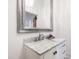 Bathroom vanity with a white marble countertop and silver framed mirror at 315 Oakwood Ave, Raleigh, NC 27601