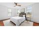 Bright bedroom with ceiling fan, wood floors, and three large windows providing natural light at 315 Oakwood Ave, Raleigh, NC 27601