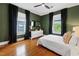 Bedroom boasts a dark green accent wall, wood floors and a ceiling fan at 315 Oakwood Ave, Raleigh, NC 27601