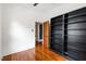 This charming bedroom features hardwood floors and a custom black bookshelf adding functional style at 315 Oakwood Ave, Raleigh, NC 27601