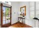Inviting foyer with hardwood floors, decorative table, and view of the outside through the glass paneled front door at 315 Oakwood Ave, Raleigh, NC 27601
