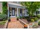 Charming front porch with beautiful landscaping and detailed front door of a historic home at 315 Oakwood Ave, Raleigh, NC 27601