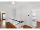 Hallway featuring hardwood floors and a white staircase railing at 315 Oakwood Ave, Raleigh, NC 27601