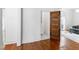 Hallway featuring a wood door, hardwood floors, and access to various rooms at 315 Oakwood Ave, Raleigh, NC 27601