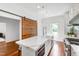 Open kitchen with an island, stainless steel appliances, and a barn door at 315 Oakwood Ave, Raleigh, NC 27601