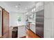 Modern kitchen with white cabinets, stainless appliances, and a functional island with seating at 315 Oakwood Ave, Raleigh, NC 27601