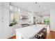 Gorgeous kitchen featuring white cabinetry, stainless steel appliances, marble countertops, and pendant lighting at 315 Oakwood Ave, Raleigh, NC 27601