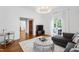 Cozy living room featuring hardwood floors, a plush sofa, and access to the outdoors at 315 Oakwood Ave, Raleigh, NC 27601