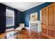 Living room has dark blue walls, hardwood floors and fireplace at 315 Oakwood Ave, Raleigh, NC 27601