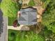 Aerial view of a beautiful home showcasing its unique roofline and manicured landscaping surrounded by trees at 341 Heather Bluffs Dr, Garner, NC 27529