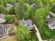 Aerial view highlighting the home's roof and landscape among many green trees at 341 Heather Bluffs Dr, Garner, NC 27529