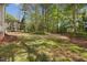 Serene backyard with mature trees, lush green grass, and a sense of privacy at 341 Heather Bluffs Dr, Garner, NC 27529