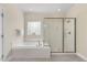 The bathroom boasts a separate glass shower and a garden tub with a tile surround at 341 Heather Bluffs Dr, Garner, NC 27529