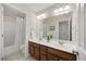 Bright bathroom with double sink vanity, shower-tub combination, and neutral color palette at 341 Heather Bluffs Dr, Garner, NC 27529