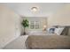 Cozy bedroom features a ceiling fan and a large window offering views of the outdoors at 341 Heather Bluffs Dr, Garner, NC 27529