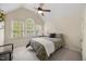 Bright bedroom features a ceiling fan and large windows offering views of the outdoors at 341 Heather Bluffs Dr, Garner, NC 27529