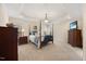 A spacious bedroom features a four-poster bed, tray ceiling with crown molding, and neutral décor at 341 Heather Bluffs Dr, Garner, NC 27529