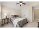 Bright bedroom features a ceiling fan and large windows offering views of the outdoors at 341 Heather Bluffs Dr, Garner, NC 27529
