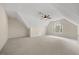 Spacious bedroom featuring a large window, a ceiling fan, and neutral carpeting at 341 Heather Bluffs Dr, Garner, NC 27529