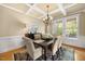 Elegant dining room featuring a coffered ceiling, hardwood floors, and a sophisticated chandelier at 341 Heather Bluffs Dr, Garner, NC 27529