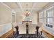 Elegant dining room featuring a coffered ceiling, hardwood floors, and a sophisticated chandelier at 341 Heather Bluffs Dr, Garner, NC 27529