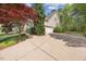Long driveway leads to a charming home with a well-manicured lawn, and a two-car garage at 341 Heather Bluffs Dr, Garner, NC 27529