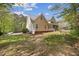 Home exterior showcasing lush landscaping, a patio, and access to the screened in porch at 341 Heather Bluffs Dr, Garner, NC 27529