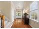 Bright foyer with hardwood floors, staircase, and front door, creating a welcoming and elegant entrance at 341 Heather Bluffs Dr, Garner, NC 27529