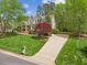 A beautifully landscaped front yard leads to a inviting home, enhanced by a colorful Japanese maple at 341 Heather Bluffs Dr, Garner, NC 27529