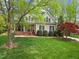 Charming home with a inviting front porch, complemented by lush landscaping and a vibrant Japanese maple at 341 Heather Bluffs Dr, Garner, NC 27529