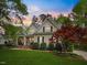 Beautiful sunset casts a warm glow on this charming home, surrounded by lush greenery and vibrant landscaping at 341 Heather Bluffs Dr, Garner, NC 27529