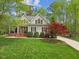 Inviting home featuring a classic front porch, well-maintained lawn, and colorful landscaping at 341 Heather Bluffs Dr, Garner, NC 27529