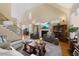 Spacious living room featuring a fireplace, stairs, and ample seating at 341 Heather Bluffs Dr, Garner, NC 27529
