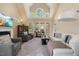 Bright living room with large windows, fireplace, and comfortable seating, creating a cozy and inviting space at 341 Heather Bluffs Dr, Garner, NC 27529