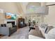 Inviting living room with a fireplace, large windows and comfortable seating area at 341 Heather Bluffs Dr, Garner, NC 27529