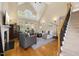 Spacious living room with vaulted ceilings, staircase, and fireplace, creating a welcoming and bright atmosphere at 341 Heather Bluffs Dr, Garner, NC 27529
