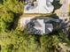 Aerial view of a home showcasing the roof, driveway, and surrounding lush greenery at 3513 Bellevue Rd, Raleigh, NC 27609