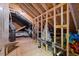 Unfinished attic space with exposed wood framing, ductwork, and various storage items at 3513 Bellevue Rd, Raleigh, NC 27609