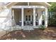 Covered back porch featuring a seating area with a fireplace, perfect for outdoor relaxation at 3513 Bellevue Rd, Raleigh, NC 27609