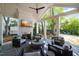 Relaxing covered back porch with a fireplace, comfortable seating, and views of the backyard at 3513 Bellevue Rd, Raleigh, NC 27609