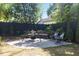 Private backyard oasis with a stone patio, cozy seating area, and lush landscaping at 3513 Bellevue Rd, Raleigh, NC 27609