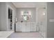 Bright bathroom with white vanity, frameless glass shower, and herringbone tile floors at 3513 Bellevue Rd, Raleigh, NC 27609