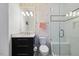 Stylishly decorated bathroom with whale wallpaper, a dark vanity, and a glass-enclosed shower at 3513 Bellevue Rd, Raleigh, NC 27609