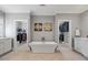 Bright bathroom featuring a soaking tub, and walk-in closets, and herringbone flooring at 3513 Bellevue Rd, Raleigh, NC 27609